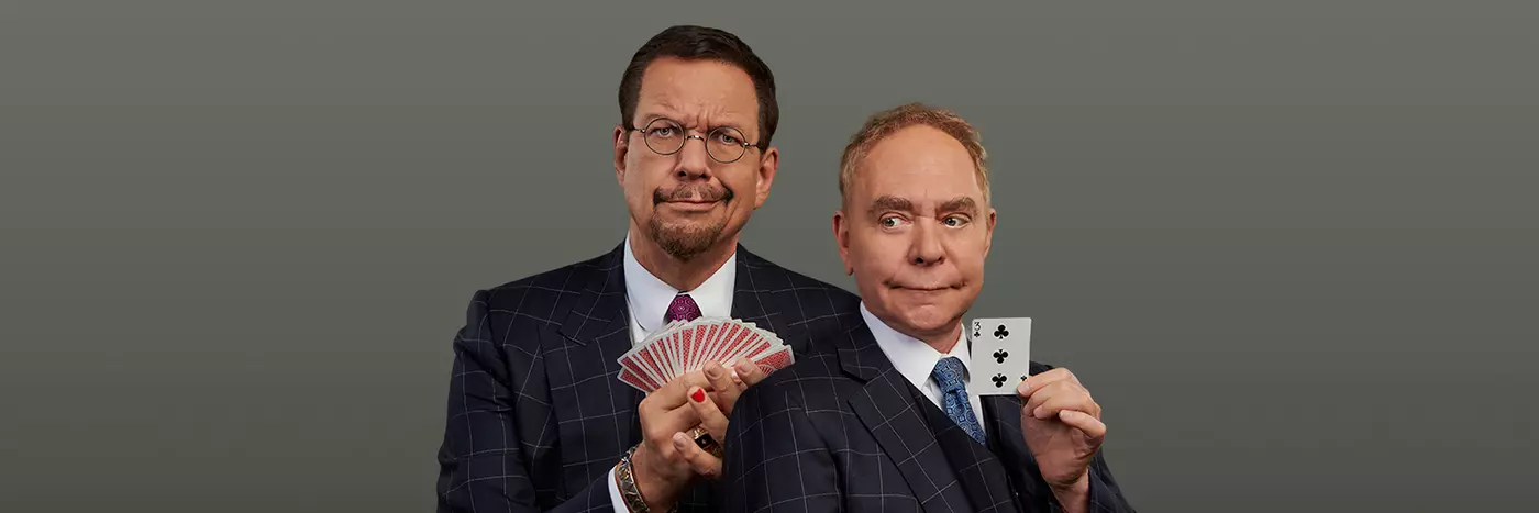 Two men in suit holding play cards, make funny faces.