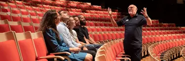 A tour guide showing the Concert Hall.