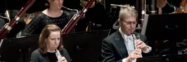 An orchestra playing flute.