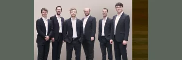 A group of six men in black suit.