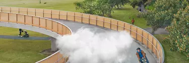 A cloud moving with a man as he cycles on a bridge.