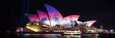The Sydney Opera House with a light display projected on it.