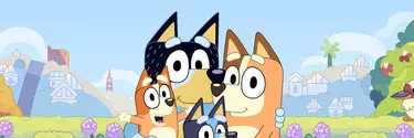 Four cartoon dogs gathered together in a field.