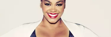 Jill Scott American singer-songwriter wearing a white dress.