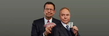 Two men in suit holding play cards, make funny faces.
