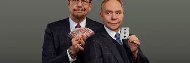 Two men in suit holding play cards, make funny faces.