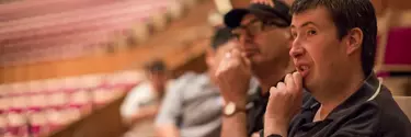 Two men sitting in the Concert Hall.