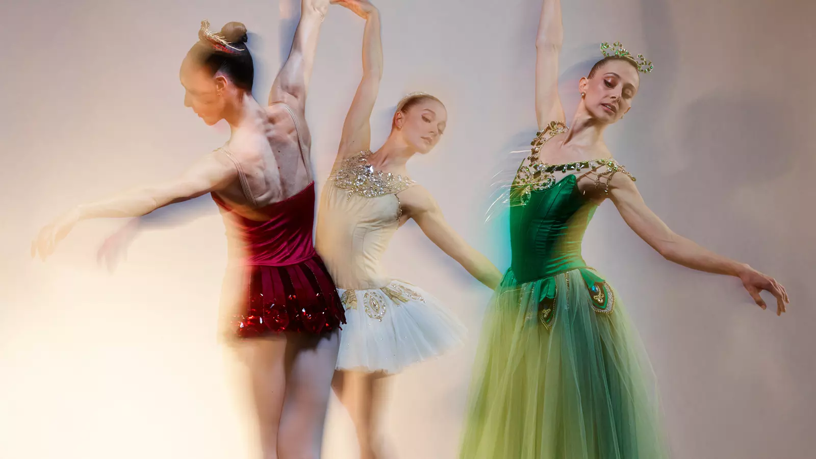 Three ballerinas doing ballet.